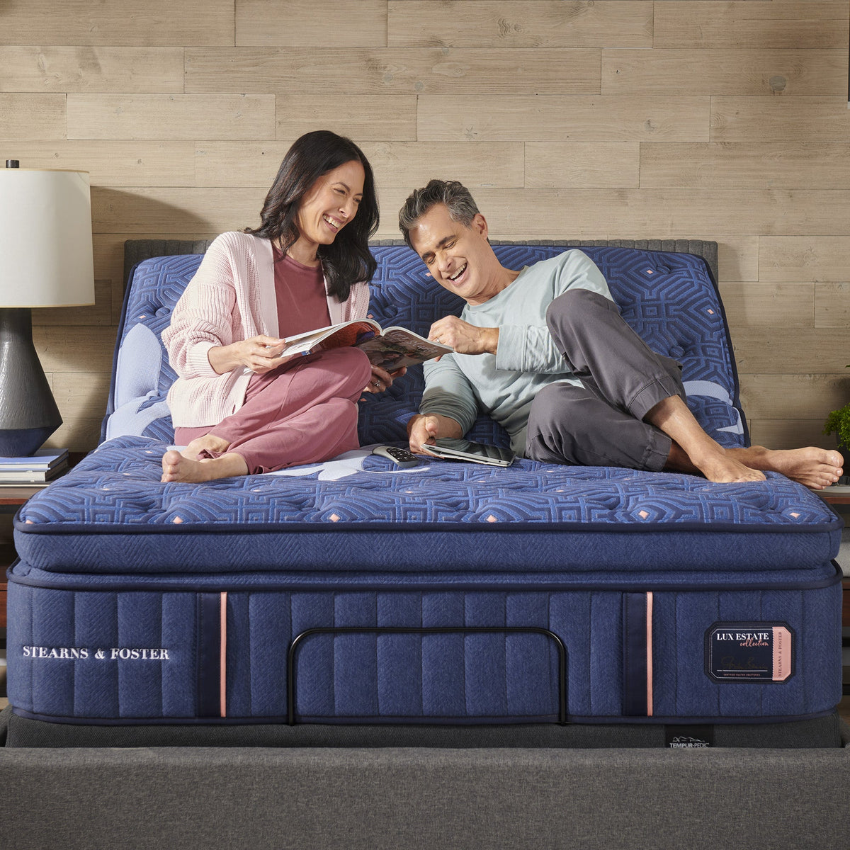 Couple relaxing on the Lux Estate Elite Medium Euro Pillow Top