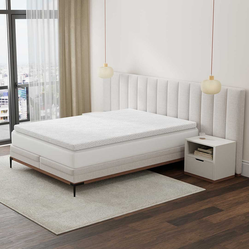 BedTech phase change cooling topper cover on a bed in a bedroom